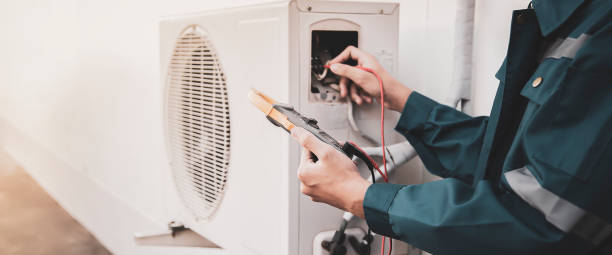 technician checking the operation of the air conditioner